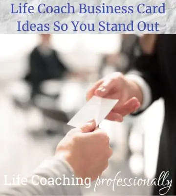 Hands exchanging business cards, showcasing an essential marketing idea for life coaches to make personal connections.